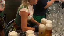 Thumbnail for Bavarian kellnerin carrying a dozen beer steins 